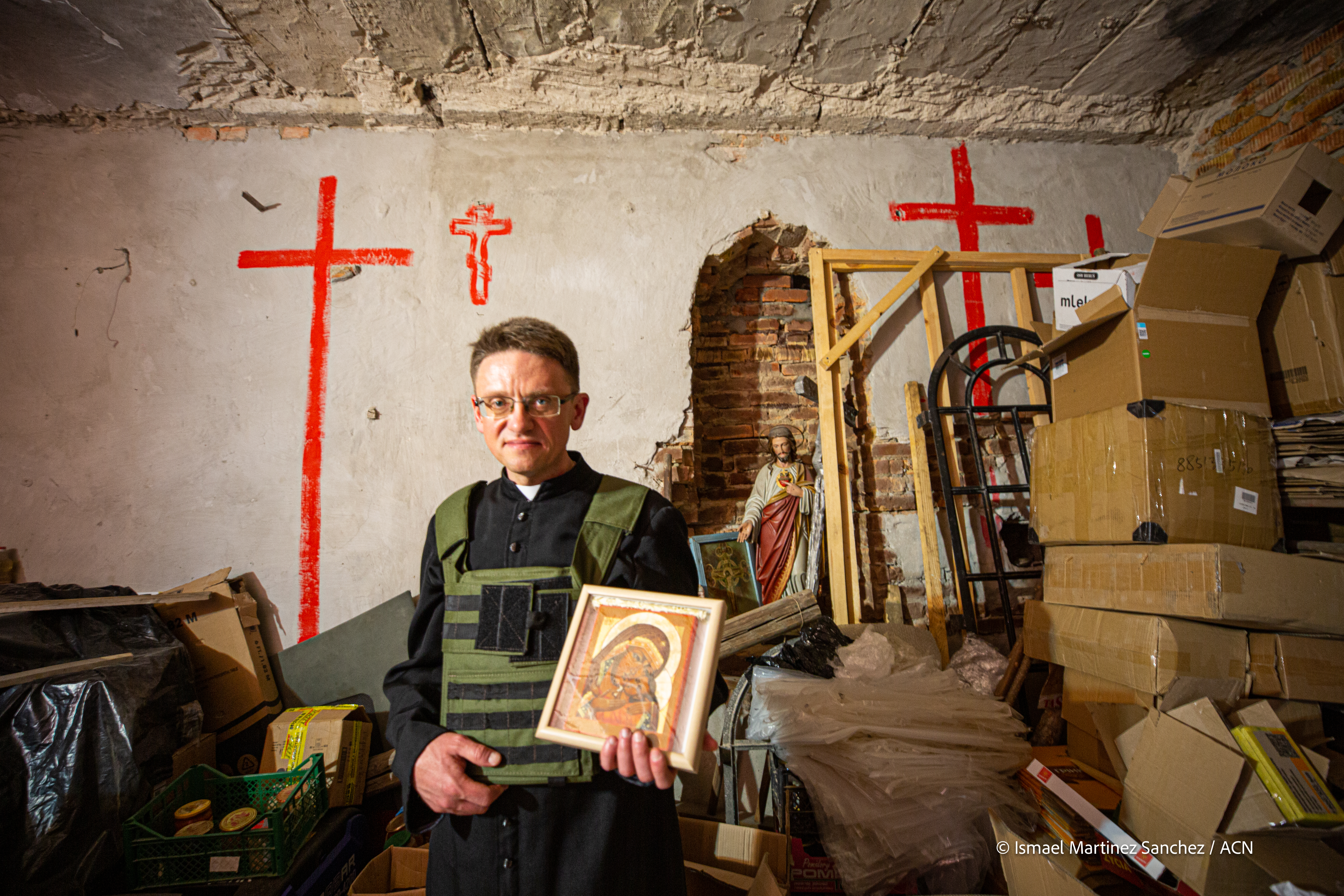 Fr Maksym, parish priest in Ukraine holding an icon