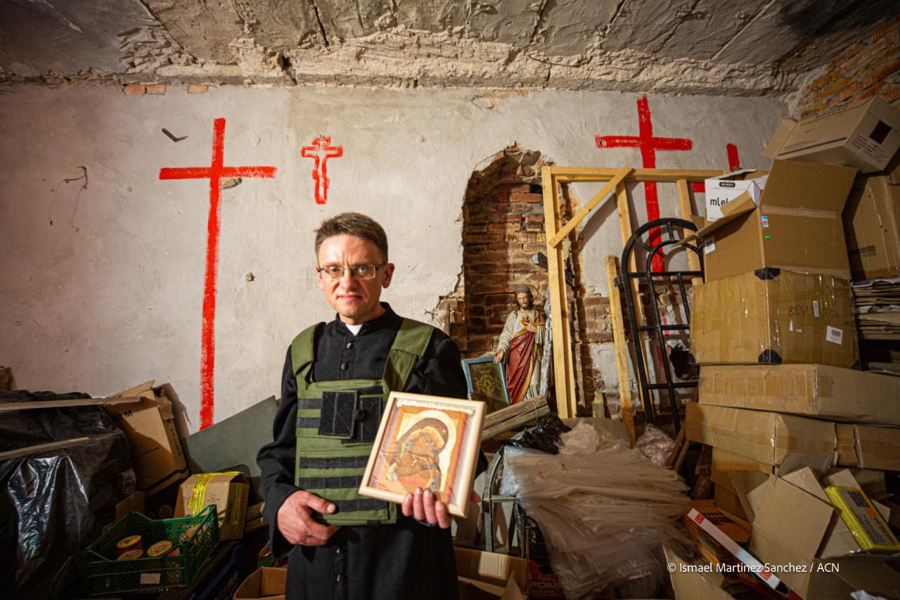 Fr Maksym, parish priest in Ukraine holding an icon