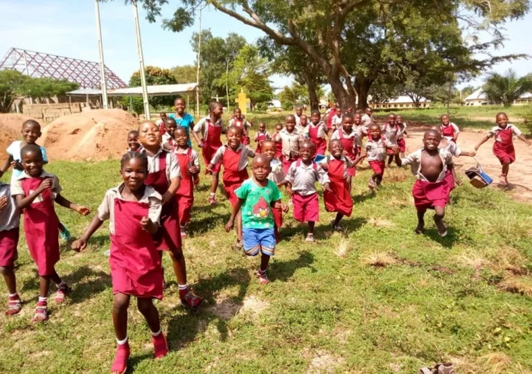 A group of happy Nigerian children running