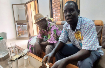 Two African men sitting on a couch