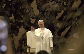 Pope Leo XIV waving to the crowd in first papal address
