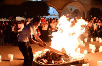 Man standing by a burning fire