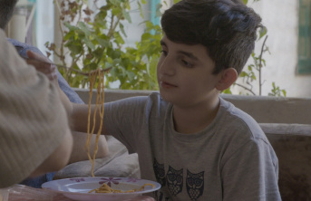 Syrian refugee Majed at home rented by Archdiocese eating lunch
