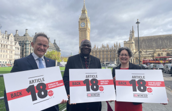 John Pontifex, Bishop John Bakeni and Dr Caroline Hull in front of Parliament holding up signs that read back article 18 