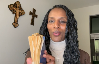 Picture of Mariam Ibrahim holding her prison Bible which she hid in her hair while imprisoned