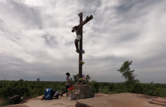 Christians praying under a crucifix
