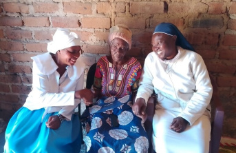 A pair of Sisters sitting with an elderly woman