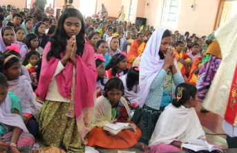 Tribal Catholic villagers celebrate the inauguration of a new school building with a Holy Mass.