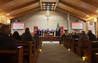A Christmas Carol service being performed with choir standing at the alter