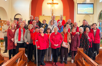 Church parish standing in front of the altar dressed in red clothing