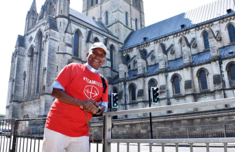 A man in a TeamRed t-shirt standing in front of a Church smiling