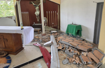 A church that has been damaged with brick walls laying on the floor