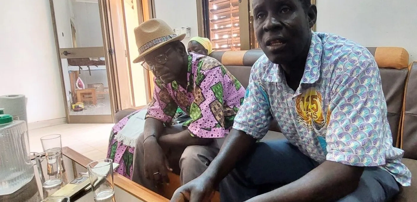 Two African men sitting on a couch