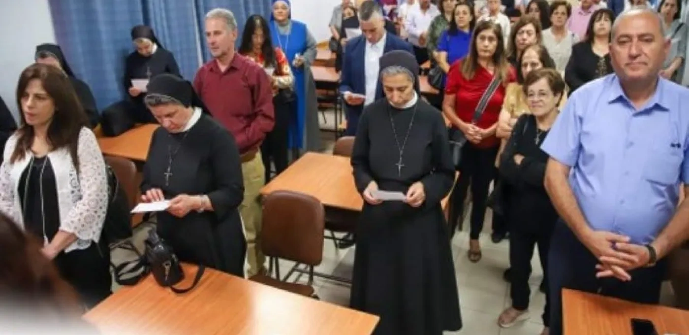 A group of people in a room with tables and chairs