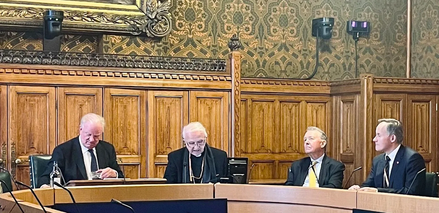 Four men sitting round a table in Parliament