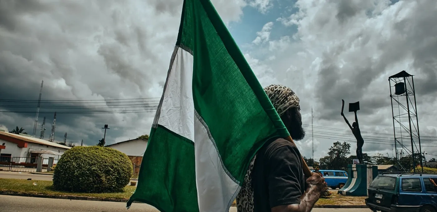 A man holding a Nigerian flag