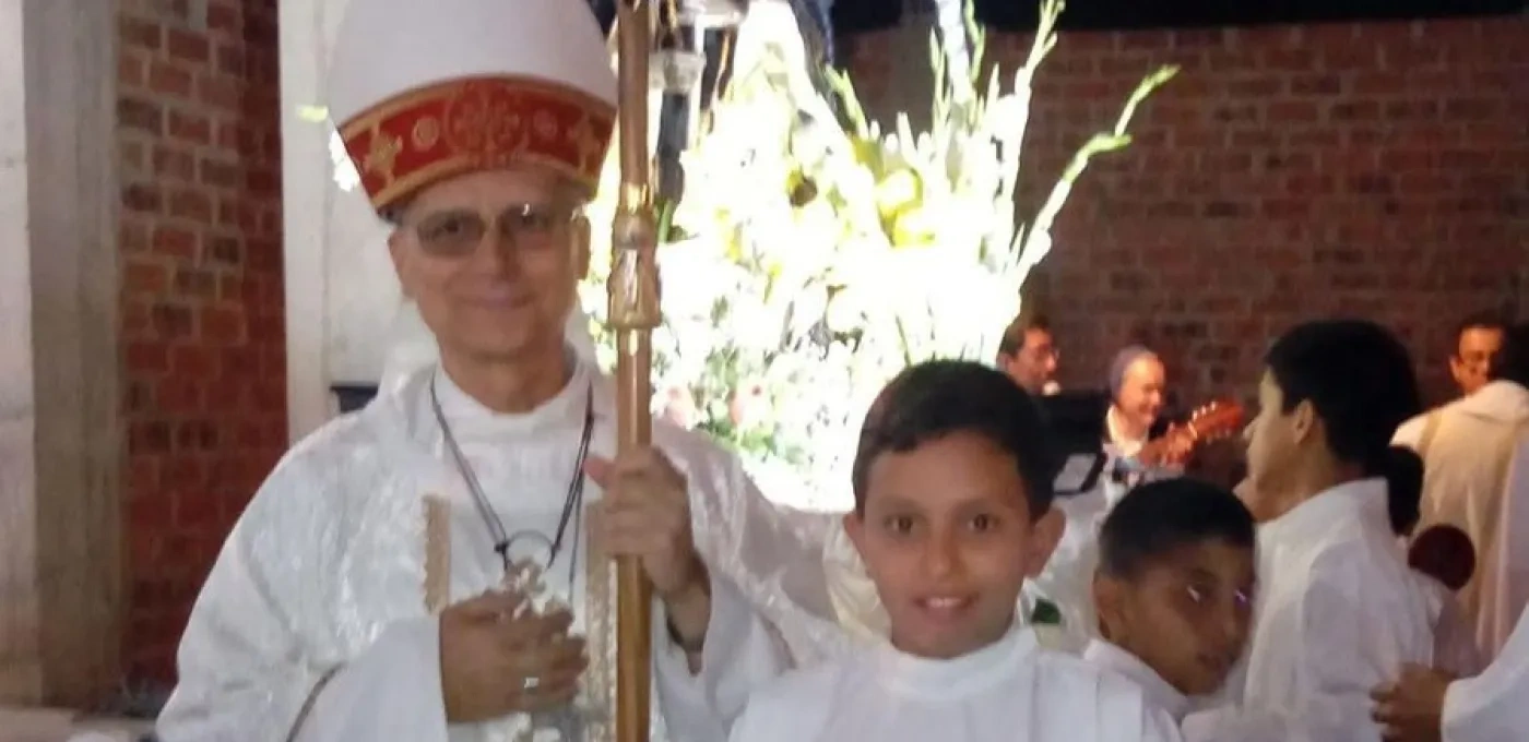 Pope Leo XIV standing next to young altar boy with a group of children behind them