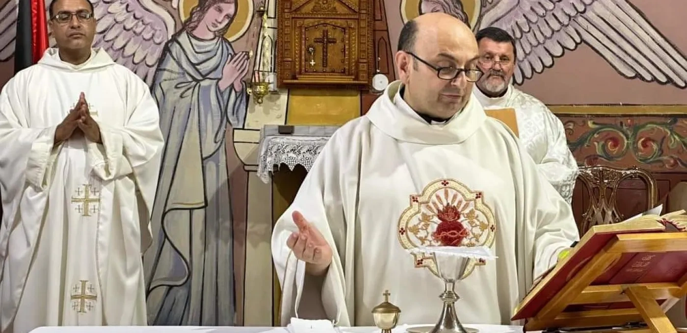 A Father delivering mass at a church altar dressed in white religious clothing