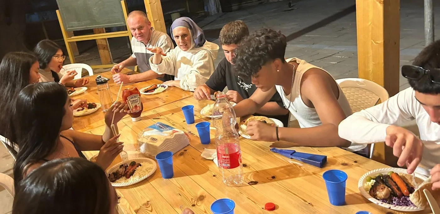 Children around a table enjoying a meal