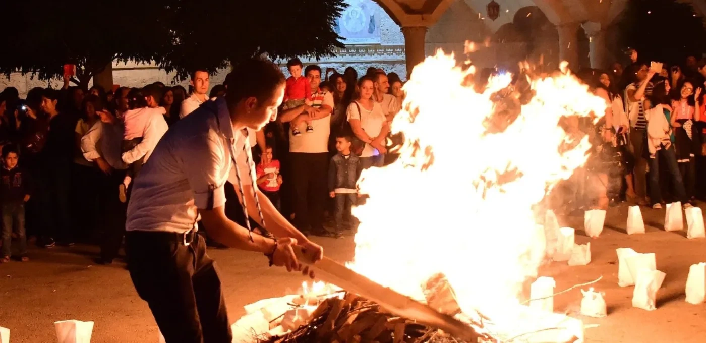 Man standing by a burning fire
