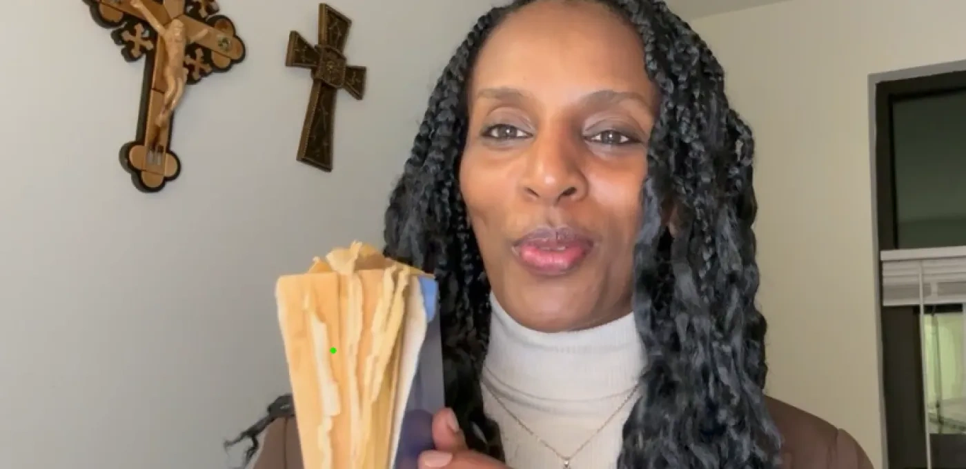 Picture of Mariam Ibrahim holding her prison Bible which she hid in her hair while imprisoned