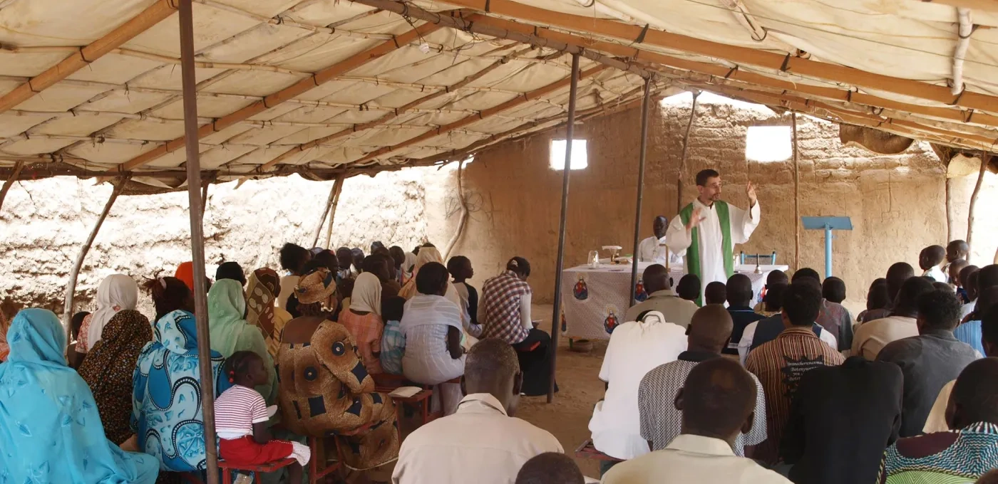 Priest with his community in Sudan