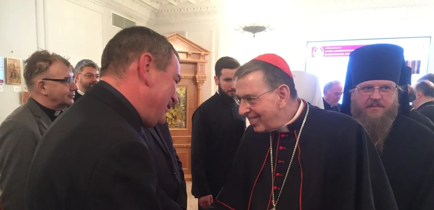 Cardinal Kurt Koch shaking hands with a person.
