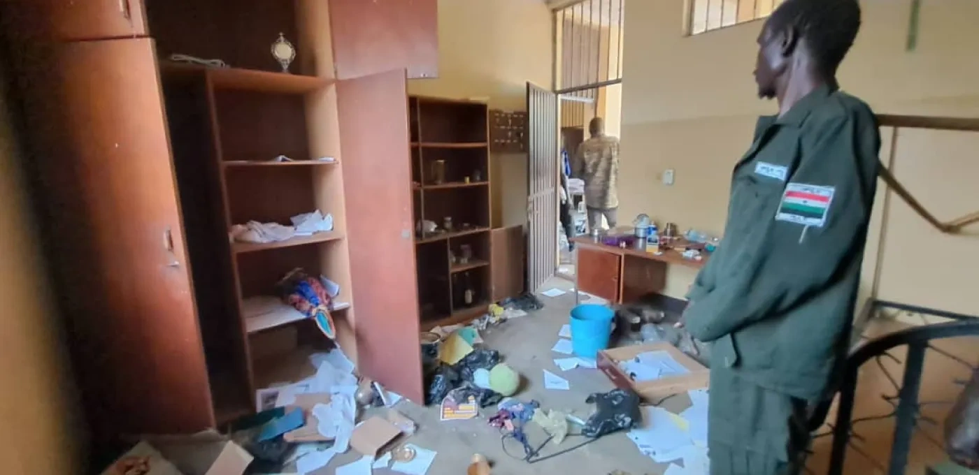 Man looks at room trashed by clashing tribes