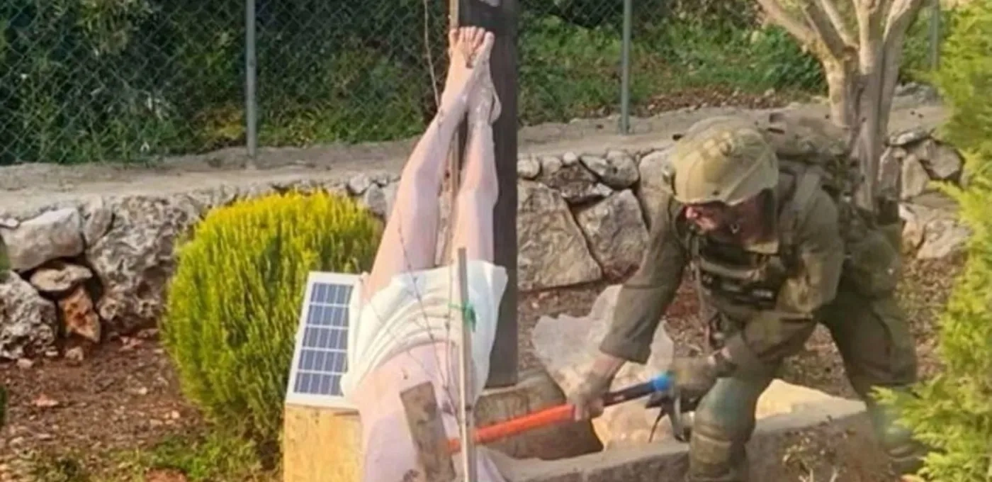 IDF soldier hitting crucifix with hammer