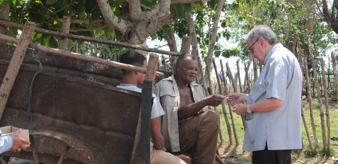 Bishop Arturo Gonzalez of Santa Clara, talking with some people in the countryside 