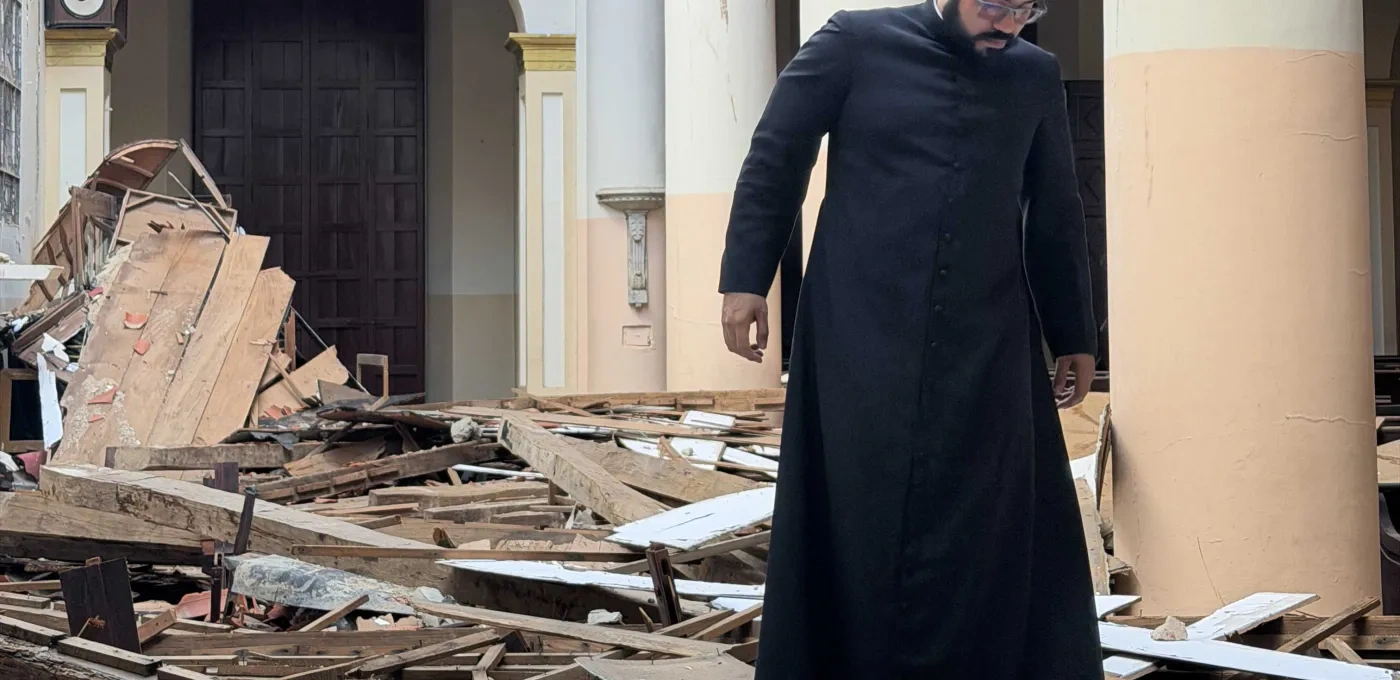 Priest investigating church ruins in Venezuela 