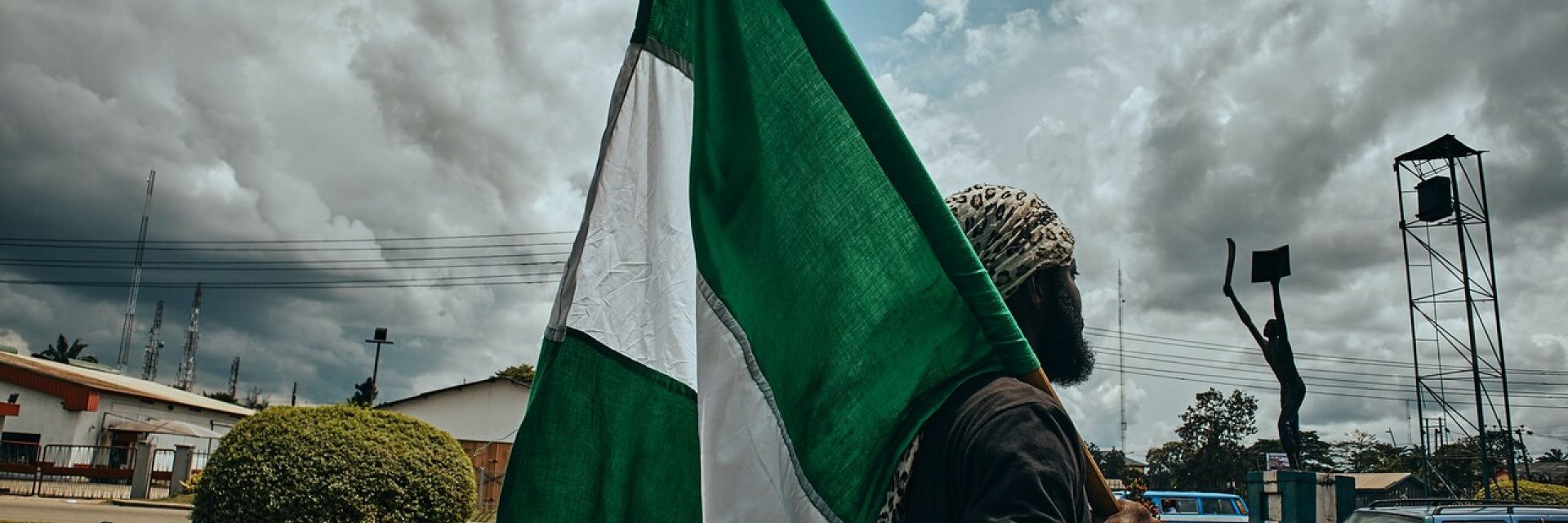 A man with a Nigerian flag in Port Harcourt, Nigeria.