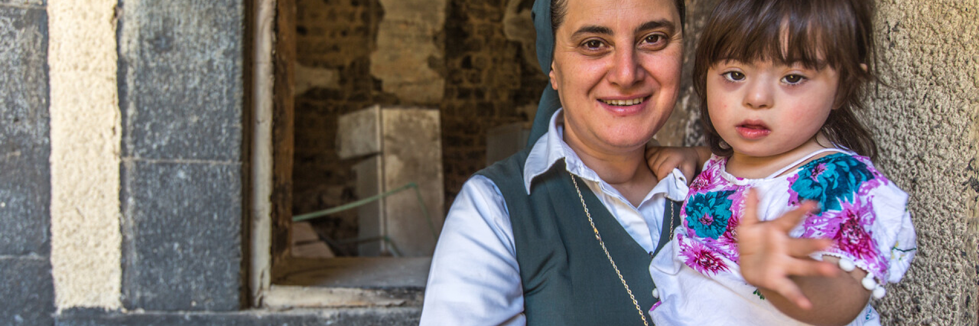 Sister Samia servant of the Holy Sisters with 3 year old girl