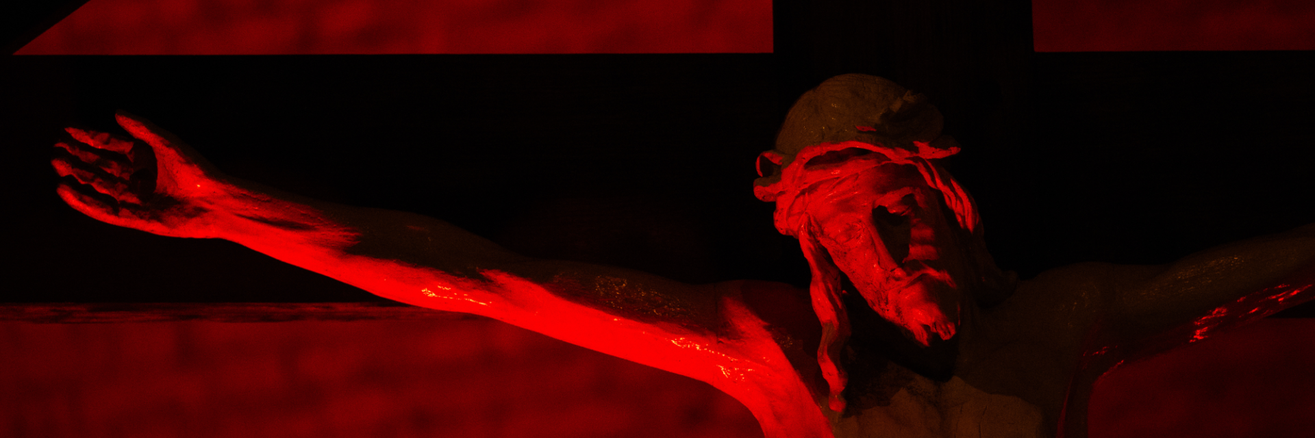 Jesus on a crucifix lit up in red