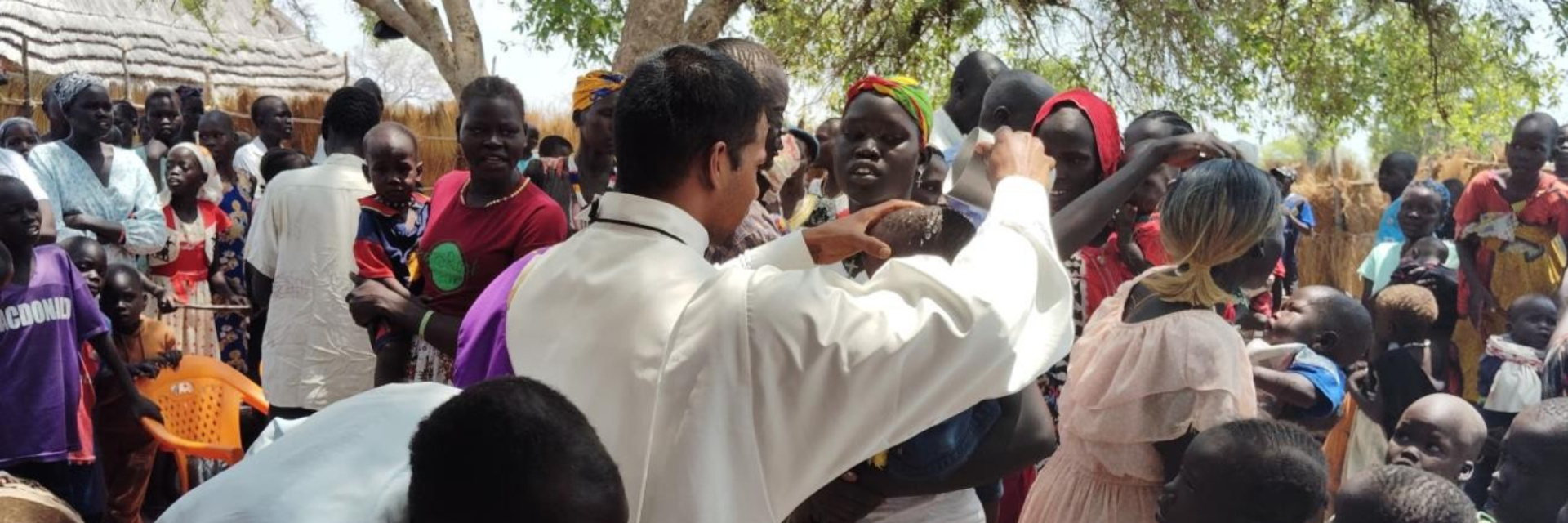 A priest performing a mass to congregation in Africa