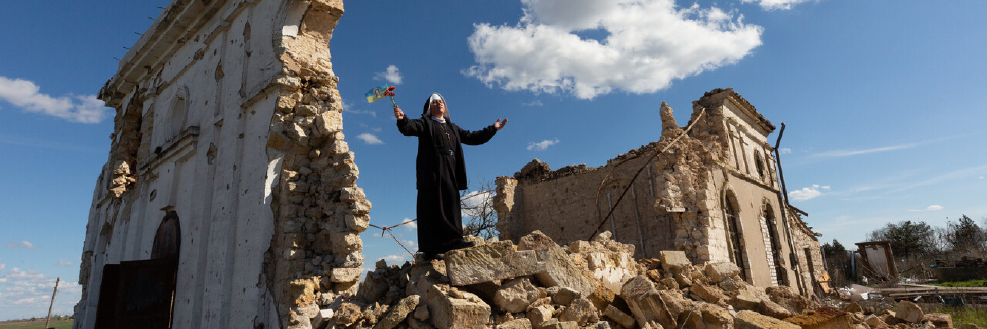 Sister standing on a church destroyed by bombings in Ukraine