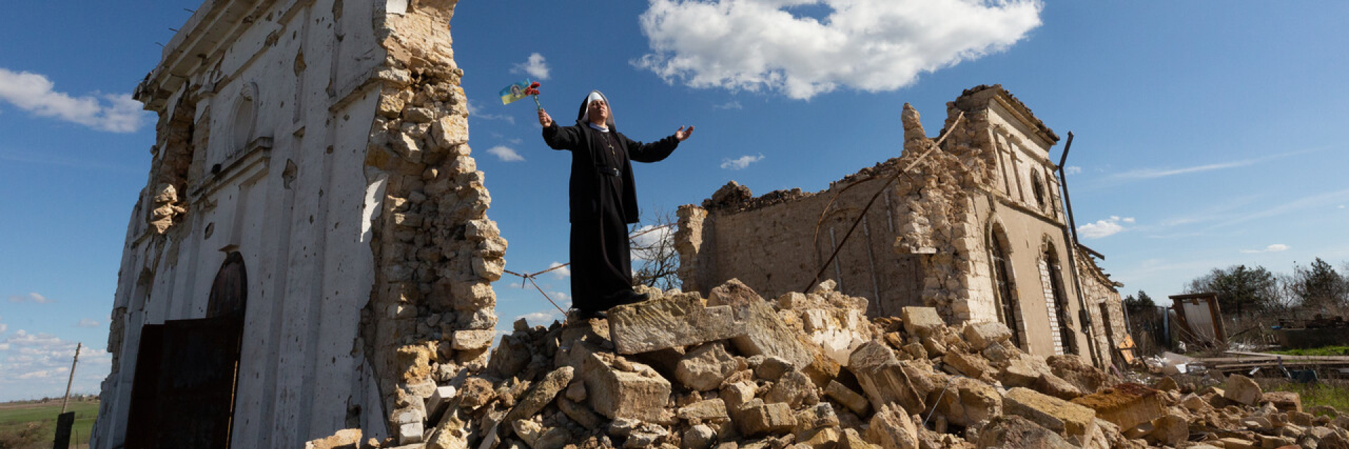 Sister standing on a church destroyed by bombings in Ukraine