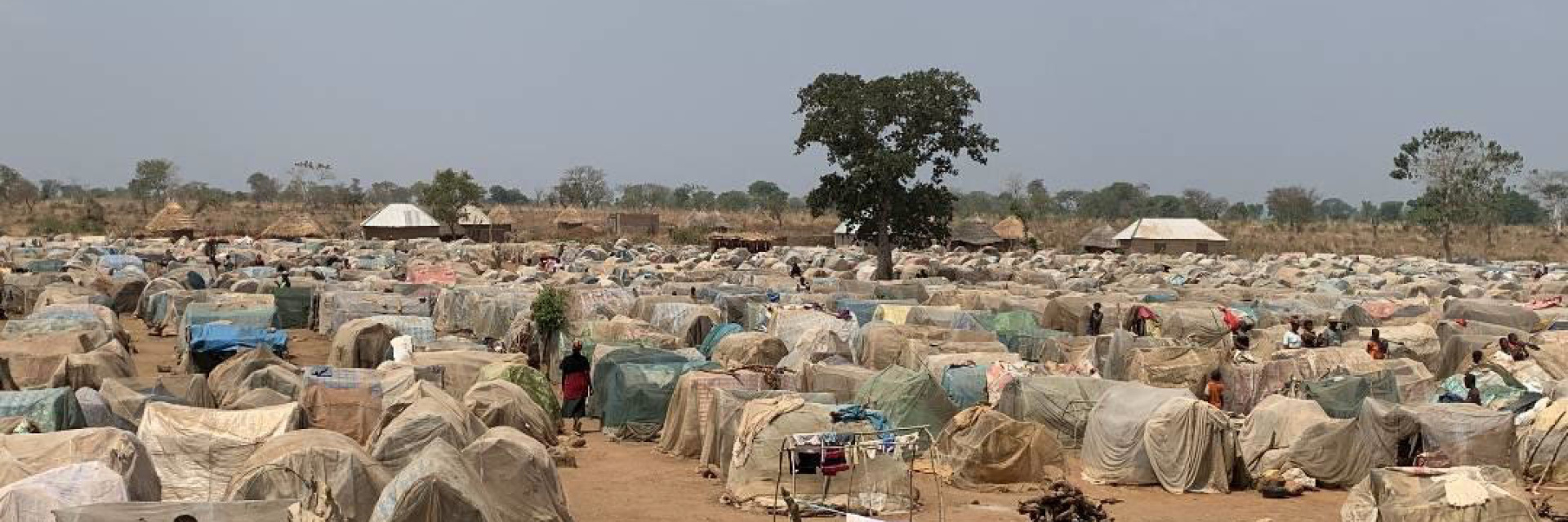 A displacement camp with lots of makeshift shelters for people displaced due to religious persecution