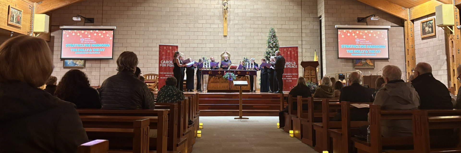 A Christmas Carol service being performed with choir standing at the alter