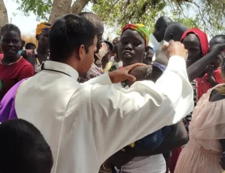 A priest performing a mass to congregation in Africa