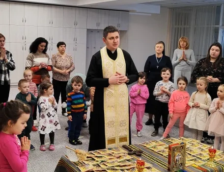 Priest visiting children at a trauma center in Ukraine