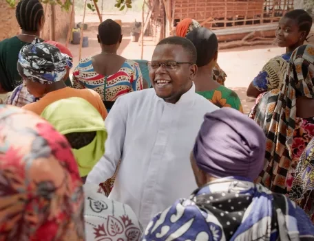 Tanzanian catechist talking with Christians