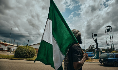 A man holding a Nigerian flag
