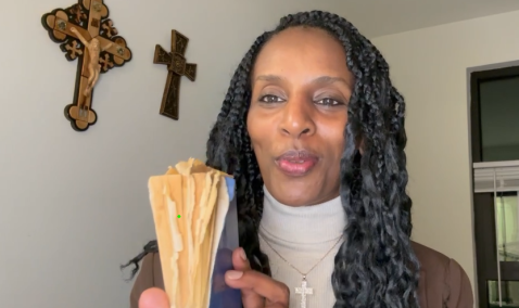 Picture of Mariam Ibrahim holding her prison Bible which she hid in her hair while imprisoned