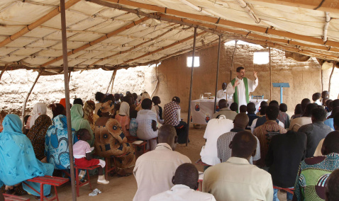 Priest with his community in Sudan