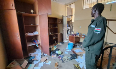 Man looks at room trashed by clashing tribes