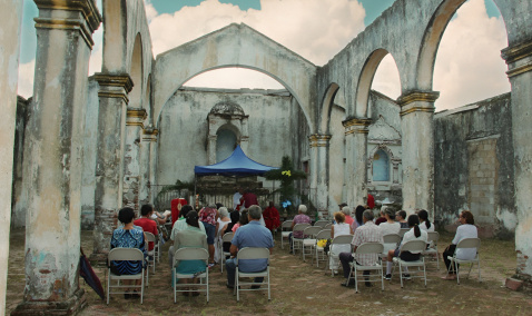 service taking place in a demolished church in Floro Perez