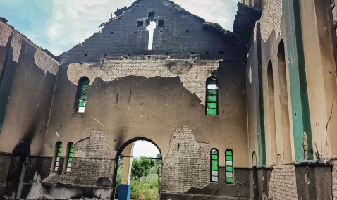 A damaged church hall including extensive burn marks and missing chapel roof