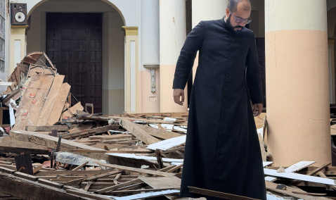 Priest investigating church ruins in Venezuela 