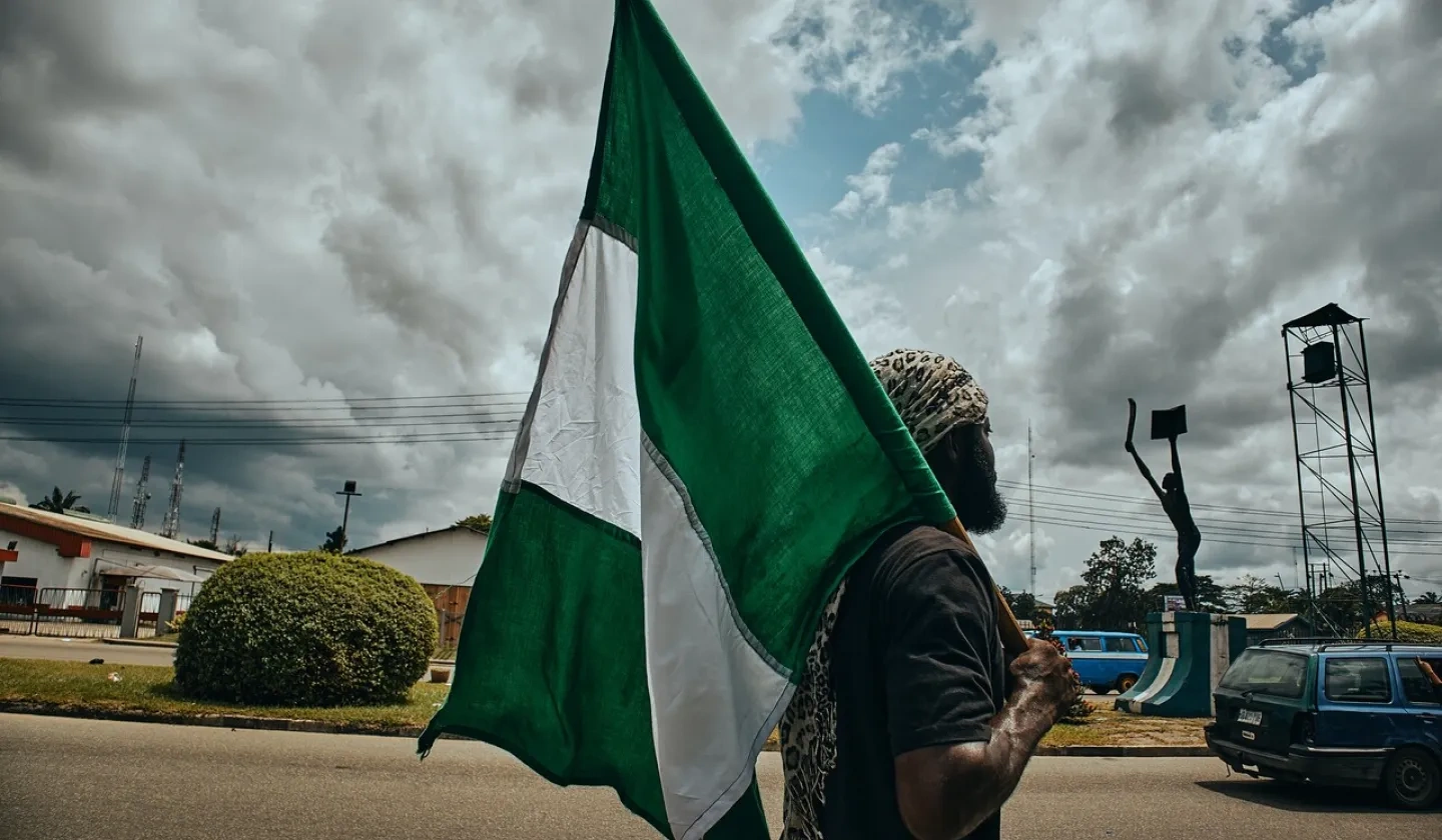 A man holding a Nigerian flag